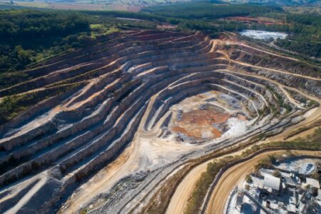 Open pit mining of raw minerals. Giant quarry. Quarry steps under the beauty sun.