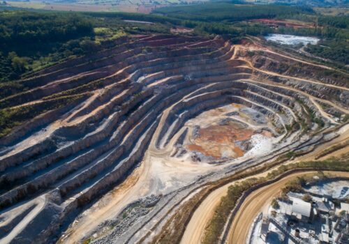 Open pit mining of raw minerals. Giant quarry. Quarry steps under the beauty sun.
