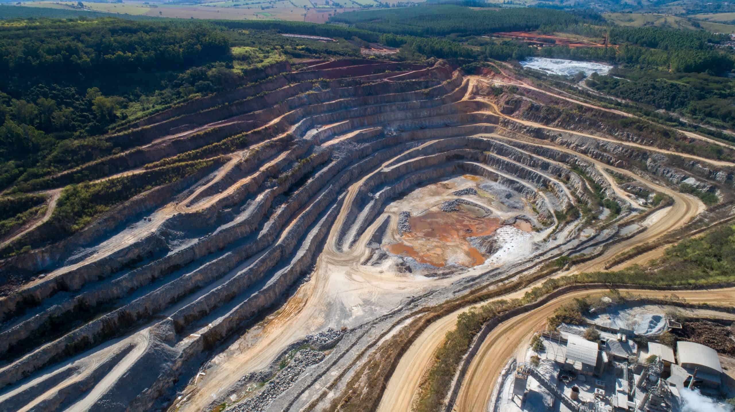 Open pit mining of raw minerals. Giant quarry. Quarry steps under the beauty sun.